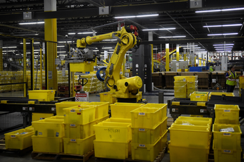 A robotic arm picks up sorting containers at the Amazon fulfillment center in Baltimore, Maryland.