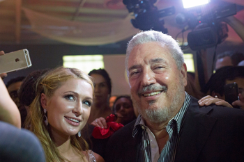 Fidel Castro Diaz-Balart, son of former Cuban leader Fidel Castro, (R), poses beside heiress Paris Hilton as she takes a selfie during the gala dinner of the closing of the XVII Habanos Festival in Havana, February 27, 2015