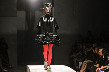A model presents a creation as part of Comme Des Garcons ready-to-wear Spring/Summer 2014 fashion collection, presented Saturday, Sept. 28, 2013 in Paris. (AP Photo/Zacharie Scheurer)