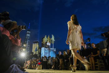 A model presents a creation from the Givenchy Spring/Summer 2016 collection, as the Tribute in Light installation shines next to One World Trade in the background, during New York Fashion Week in New York September 11, 2015.