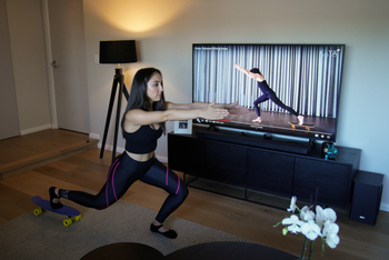 Sydney resident Alexandra Gallo follows an online Pilates class at home.