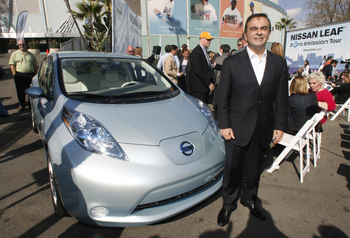 Nissan president and CEO Carlos Ghosn poses with the Nissan Leaf all-electric vehicle, a five-passenger hatchback, during its North American debut at the Nissan Leaf Zero Emissions Tour stop in Los Angeles, California November 13, 2009. REUTERS/Fred Prouser