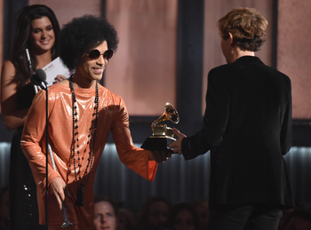 Prince, left, presents Beck with the award for album of the year for Morning Phaseat the 57th annual Grammy Awards on Sunday, Feb. 8, 2015, in Los Angeles. (Photo by John Shearer/Invision/AP)
