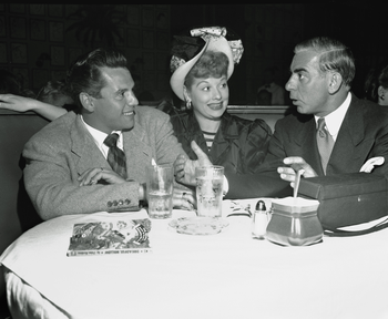 Eddie Cantor, right, talks with comedienne Lucille Ball, center, and her husband Desi Arnaz during dinner at Los Angeles&#039; Brown Derby, Oct. 10, 1946. (AP Photo)