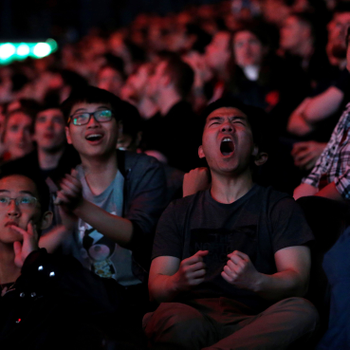 Esports fans react as they watch on from the stands.