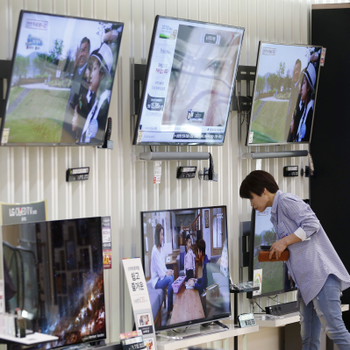 A woman looks at televisions at its store in Seoul, South Korea.