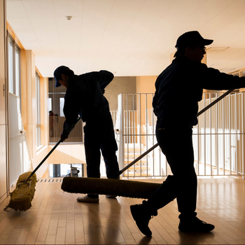 Tokyo Electric Power Co. employees mops floors of a school.