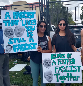 Young protestors hold placards denouncing fascism outside the Howdy, Modi! event in Houston, Texas.