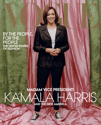Kamala Harris in a Donald Deal blazer and black Chuck Taylor sneakers in front of a pink and green backdrop on the cover of Vogue.