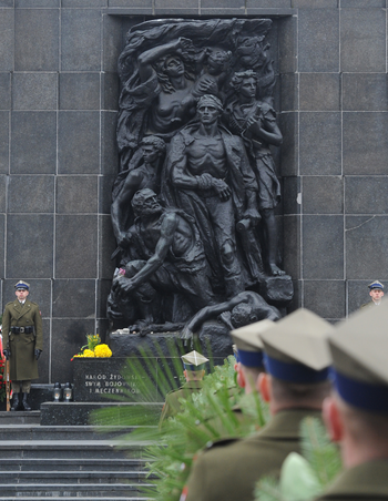 Polish Army soldiers holding wreaths line up in front of the Warsaw Ghetto Heroes memorial during commemorations marking the 73rd anniversary of the start of the Warsaw Ghetto Uprising, in Warsaw, Poland, Tuesday, April 19, 2016.