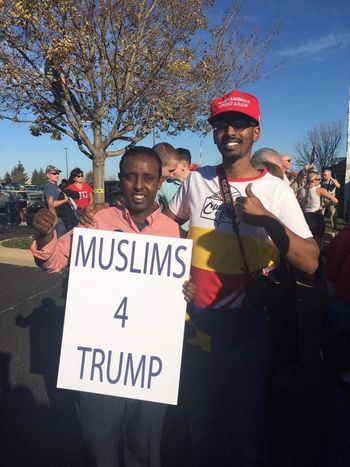 Abdi Rage (right) in a Make America Great Again hat.