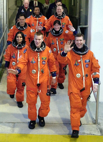 The space shuttle Columbia crew departs their quarters for the launch at the Kennedy Space Center in Cape Canaveral, Florida January 16, 2003. Clockwise from lower left are Pilot Wille McCool, Kalpana Chawla, who was raised in India, Ilan Ramon, the first Israeli to travel on the space shuttle, Michael Anderson, David Brown, Laurel Clark and Mission Commander Rick Husband in lower right. The shuttle is beginning a 16-day scientific research mission.
