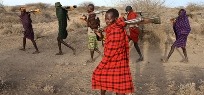 Turkana tribesmen walk with guns in order to protect their cattle from rival Pokot and Samburu tribesmen near Baragoy, Kenya February 14, 2017.