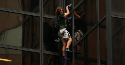 A man climbs the outside of Trump Tower in New York on Aug. 10.
