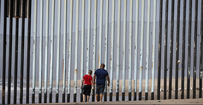 Two people walk towards metal bars marking the United States border where it meets the Pacific Ocean Wednesday, March 2, 2016, in Tijuana, Mexico. Former Mexican President Vicente Fox on Wednesday stood by his comparison of Donald Trump to Adolf Hitler, saying the Republican presidential front-runner believes in the white supremacy. Fox is calling on Americans to wake up from this Republican nightmare. He made the remarks Wednesday in an interview taped for Fox News Channels Hannity. Trump has angered many Mexicans for his campaign rhetoric denigrating some immigrants as "rapists" who bring crime and drugs to the United States, and his promise to build a wall along the entire US-Mexico border.