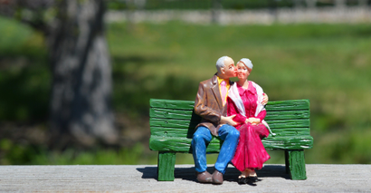 Old couple figurines sat on bench