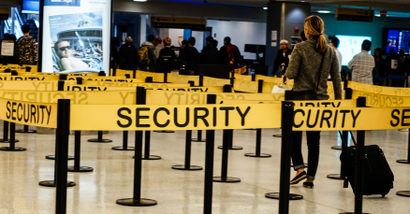Passengers make their way in a security checkpoint at the International JFK airport in New York October 11, 2014.