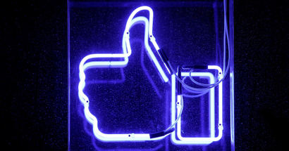 a neon facebook like thumbs-up button