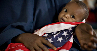 A malnourished Somali child is wrapped in an American "Stars and Stripes" cloth at a therapeutic feeding center at Dagahaley camp in Dadaab in Kenya's northeastern province, June 8, 2009. Weeks of intense fighting in Somalia has driven mor than 100,000 people from their homes, swelling camps on the Kenyan border that are already the largest and oldest in the world, sheltering more than 270,000 Somali refugees. Picture taken June 8, 2009.