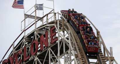 People ride the famous wooden roller coaster "Cyclone" at Coney Island, New York October 27, 2012.