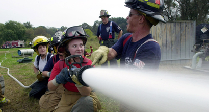 firefighters with a hose