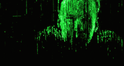 An animated gif of Neo from the movie The Matrix putting on his sunglasses. As he does, the picture changes to a black background with green computer code.