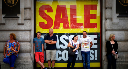 People stand outside a sports retailer in Piccadilly Circus, in central London August 15, 2013. British retail sales rose at their fastest annual rate in over two years in July as a heat wave boosted sales of barbecue food and outdoor items, official data showed on Thursday. Retail sales volumes jumped 1.1 percent on the month, almost twice as fast as expected to give an annual rise of 3.0 percent, the highest since January 2011. REUTERS/Andrew Winning (BRITAIN - Tags: BUSINESS POLITICS SOCIETY) - RTX12MDN