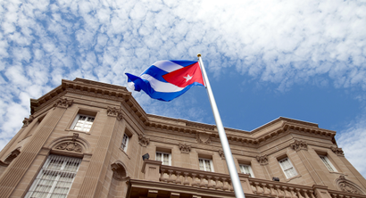 The Cuban flag is raised over their new embassy in Washington, Monday, July 20, 2015. Cuba's blue, red and white-starred flag was hoisted Monday at the country's embassy in Washington in a symbolic move signaling the start of a new post-Cold War era in U.S.-Cuba relations.