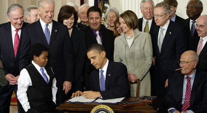 In this March 23, 2010, file photo, President Barack Obama signs the health care bill in the East Room of the White House in Washington. With the nation still divided over "Obamacare," President Barack Obama is laying out a blueprint for addressing unsolved problems with his signature health law, including a renewed call for a "public option" to let Americans buy insurance from the government.
