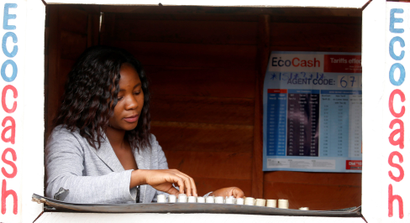 A woman counts bond coins at a mobile money shop in Mbare,Harare