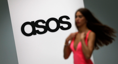 A model walks on an in-house catwalk at the ASOS headquarters in London April 1, 2014. British online fashion retailer ASOS posted a 22 percent fall in first half profit, reflecting its move to step-up the pace of infrastructure investment to meet future demand. The firm said on Wednesday it made a pretax profit of 20.1 million pounds ($33.4 million) in the six months to Feb. 28, down from 25.7 million pounds in the same period last year. Picture taken April 1, 2014. REUTERS/Suzanne Plunkett (BRITAIN - Tags: BUSINESS FASHION) - RTR3JKGZ