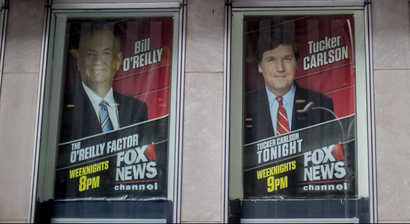 Posters of Fox News Channel personalities are displayed at the News Corp. headquarters in New York, Wednesday, April 19, 2017. There was no immediate response from Bill O'Reilly's bosses to escalating reports that the Fox News Channel personality will lose his job following accusations he had harassed women. New York magazine said Wednesday that Rupert Murdoch and his sons James and Lachlan, who run Fox parent 21st Century Fox, had decided that O'Reilly was out and executives were planning the exit. (AP Photo/Mary Altaffer)