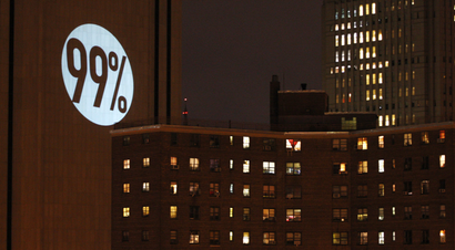 A sign is projected on the Verizon Building by Occupy Wall Street demonstrators in New York
