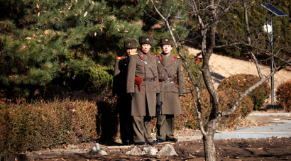 North Korean soldiers keep watch toward the south next to a spot where a North Korean has defected crossing the border on November 13, at the truce village of Panmunjom inside the demilitarized zone, South Korea, November 27, 2017.