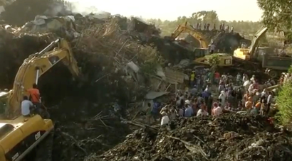 Excavators work after a landslide at a garbage dump on the outskirts of Addis Ababa, Ethiopia in this still image taken from a video from March 12, 2017.