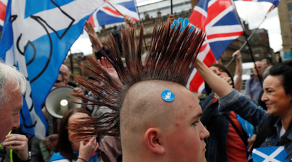 Demonstrators wave flags at a march in support of Scottish independence, in Glasgow, Scotland, Britain June 3, 2017. REUTERS/Russell Cheyne - RTX38TK0