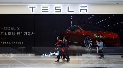 People walk past a planned store of Tesla in Hanam, South Korea, December 22, 2016.