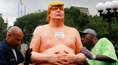 New York City Parks workers move a naked statue of U.S. Republican presidential nominee Donald Trump