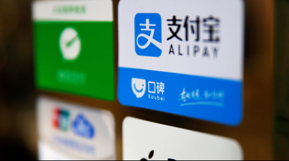 An Alipay logo is seen among other paying method stickers on the doors of a restaurant at the Beijing Railway Station in central Beijing