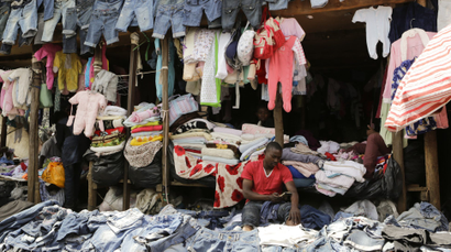 A trader (R) waits for customers at his stall selling secondhand clothes locally known as 'mitumba' at the Gikomba open-air market in Nairobi, Kenya, 27 July 2016. The Gikomba market in Nairobi is said to be the biggest second-hand clothes market in East Africa with close to 65,000 traders. The second-hand clothes sold in Gikomba are mostly imported from North America and Europe, according to a trader at the market. While 'mitumba' is considered to have brought down the market for locally made clothes and fabrics, it has also opened new opportunities for business people and new upcoming designers and stylists who rely on the second-hand clothes in their daily work as the second-hand clothes are considered to be easily available, affordable and provide a wide range of fashion styles, colors and fabrics compared to locally manufactured fashion apparels. Therefore they sell faster and in large quantities