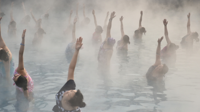 Women stretch arms at a hot spring