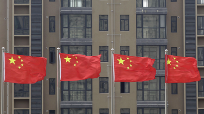 DATE IMPORTED:July 10, 2012Chinese national flags fly in front of a newly-built residential apartment in Wuhan, Hubei province July 10, 2012. China must firmly maintain its property tightening measures to cool housing prices, Premier Wen Jiabao was quoted as saying on Saturday, underscoring official concerns about renewed bubbles as the central bank ratchets up policy easing to support growth. REUTERS/Stringer
