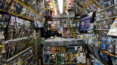 A Palestinian watches news from Egypt on television inside his shop in Jerusalem's Old City, Thursday, Feb. 3, 2011.