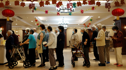 Residents queue for their buffet lunch at Heyuejia, a care home for the elderly, in Beijing, China May 26, 2021.