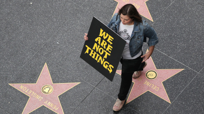 A demonstrator takes part in a #MeToo protest march for survivors of sexual assault and their supporters on the Hollywood Walk of Fame in Hollywood,