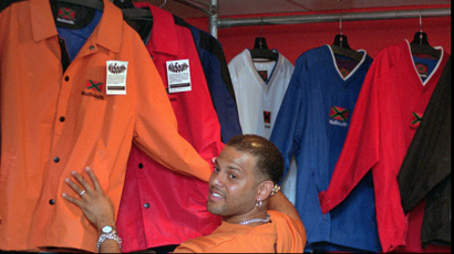 NuSouth co-founder Angel Quintero, pictured in 1999, looks through a rack of jackets in the brand's Charleston, SC store.