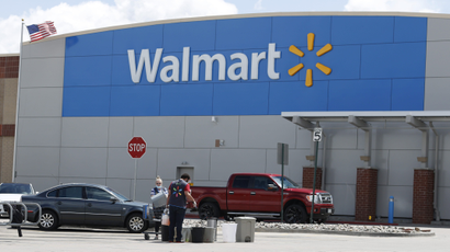Workers sanitize items outside a Walmart