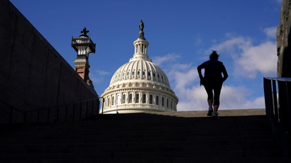 A woman exercises on steps at the U.S. Capitol