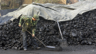 A Chinese man shovels coal