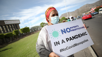 A woman holds a placard during a protest against Covid-19 vaccination distribution inequality outside the Johnson and Johnson offices in Cape Town earlier this month.
